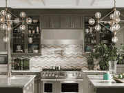 Lifestyle view of the 30 Inch 1200 CFM VICTORY Hurricane installed in a luxury kitchen, showcasing its seamless under-cabinet fit and professional stainless steel finish