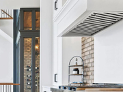 Side angle of 30 Inch 750 CFM Range Hood Insert installed flush within modern white kitchen cabinetry