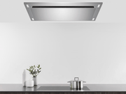 Lifestyle view of a stainless steel 600 CFM Flush Ceiling Mount Range Hood installed flush over a modern kitchen island for an unobstructed, open-concept look