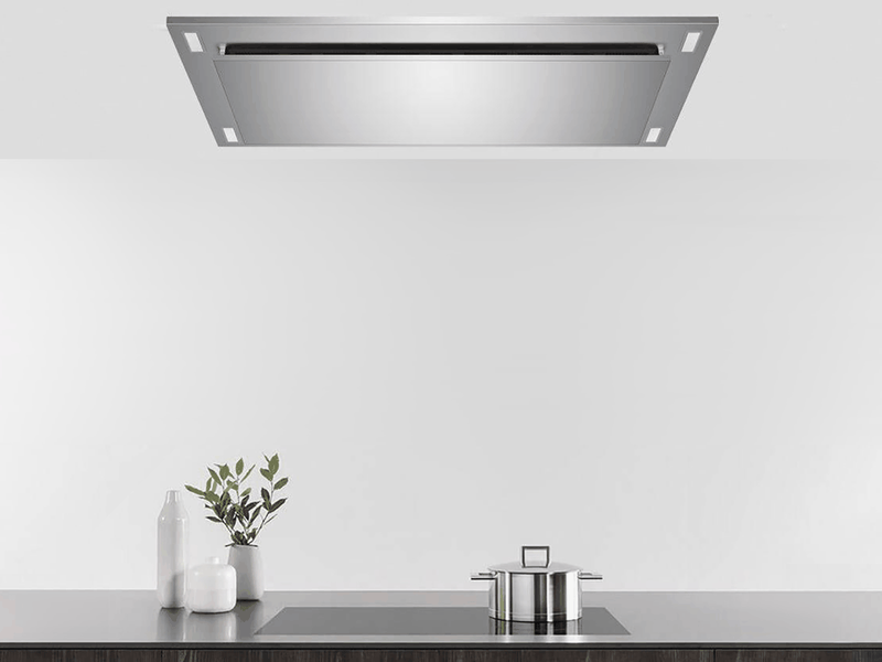 Lifestyle view of a stainless steel 600 CFM Flush Ceiling Mount Range Hood installed flush over a modern kitchen island for an unobstructed, open-concept look