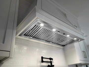 Built-in range hood showing dimmable LED lights and durable mechanical rotary knobs for precise airflow control