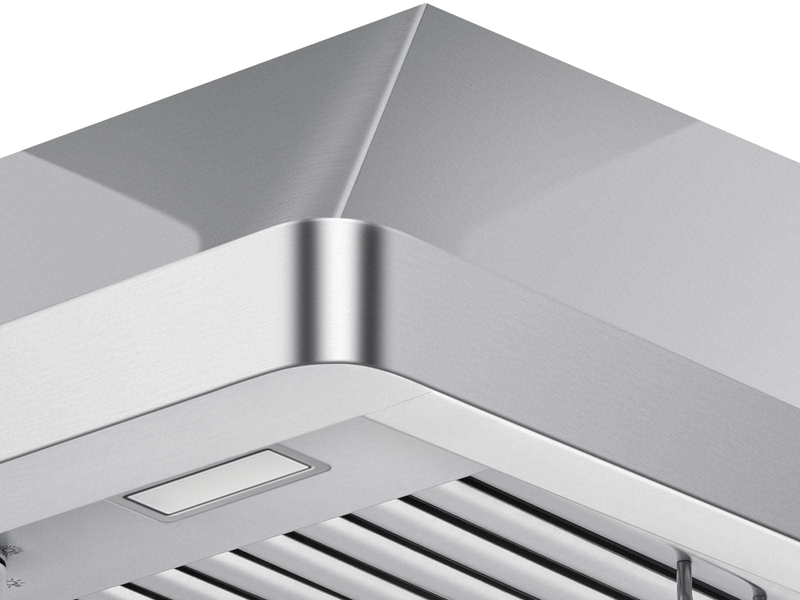 Close-up view of the Verona stainless steel range hood corner with LED light and baffle filter detail