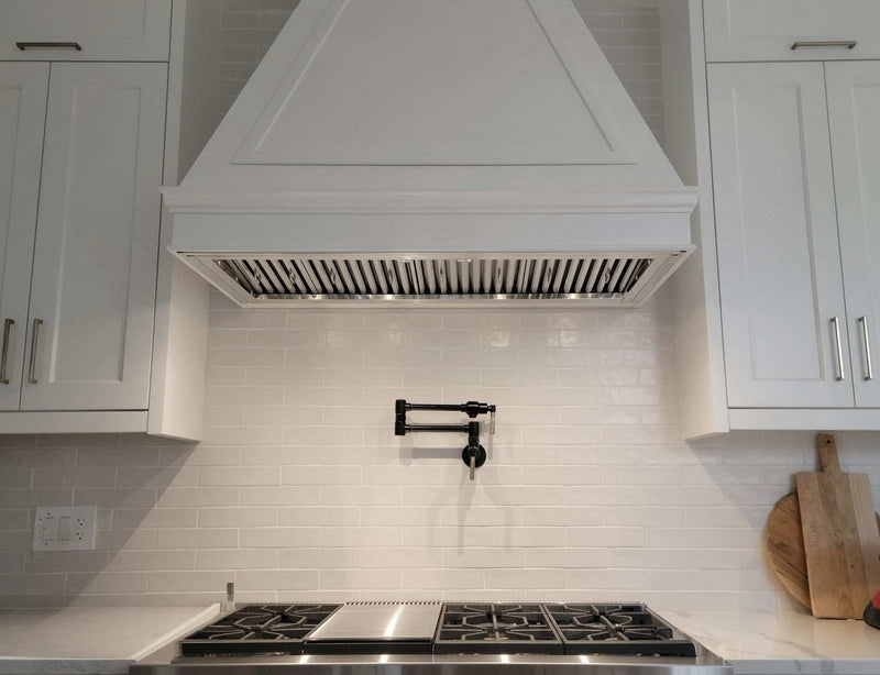 48 Inch 1200 CFM Range Hood Insert in custom white cabinetry showing 20-inch deep stainless baffle filters for full cooktop coverage